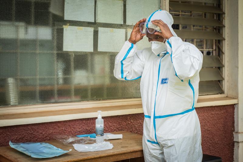 Health worker dons PPE in Kenya.