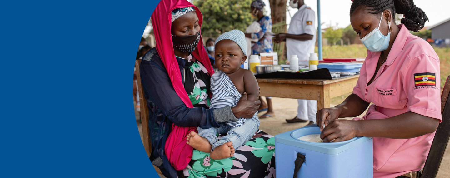 A Ugandan health worker speaks with a mother and her baby.