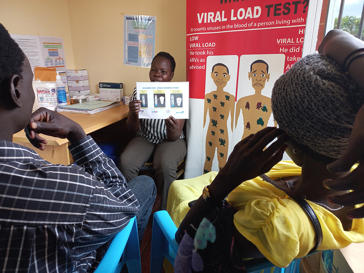 A health worker provides HIV pretest counseling and teaches the couple how to use male and female condoms at the Kimu Primary Health Care Center in Juba. Photo by Gladys Achan for IntraHealth International.